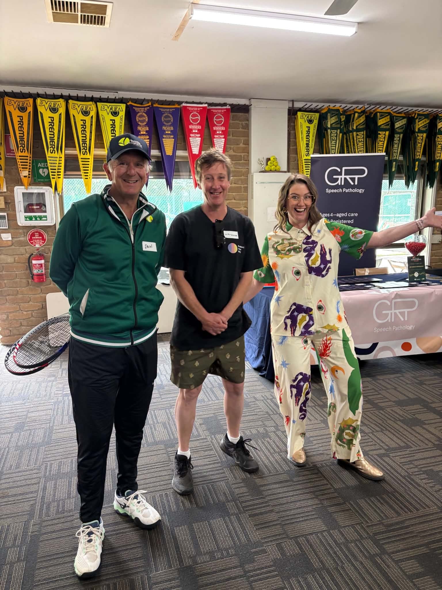 Three people posing inside the clubrooms at Tennis Together Day