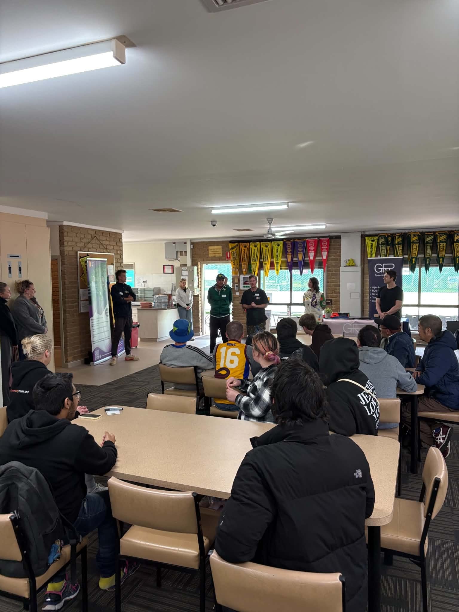Large group gathered inside the Norris Bank clubrooms for Tennis Together Day