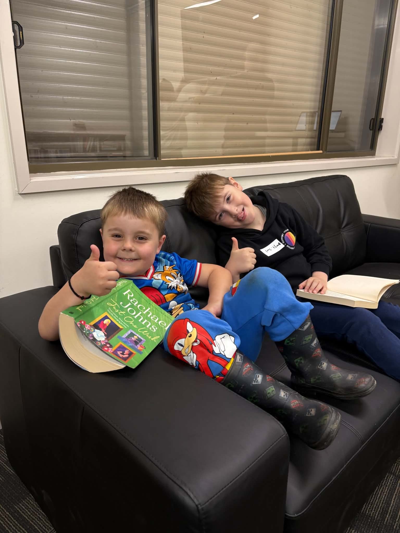 Two boys relaxing on the couch at the club